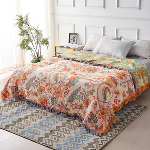 Rustic floral boho cotton throw blanket on a bed