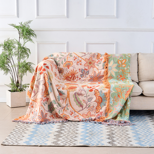 Rustic floral boho cotton throw blanket draped on a sofa