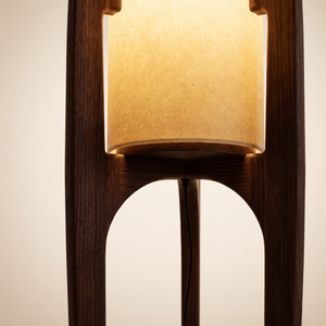 Solace Sculptural Floor Lamp detail - walnut tripod frame and glowing shade