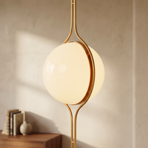 Oris floor to ceiling lamp in Gold against a warm limewash wall beside a walnut console