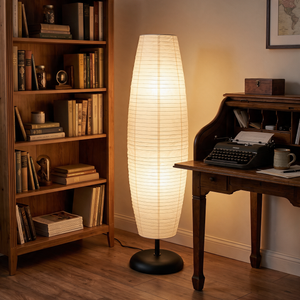 Anara floor lamp lighting a study with a bookcase and writing desk, matte black dome base