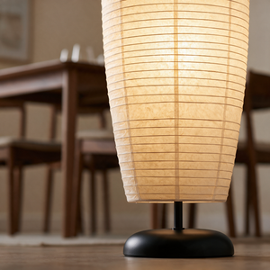 Close up of the Anara rice paper shade and matte black dome base in a dining room