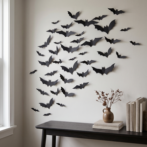 Black 3D bats mounted climbing a living room wall above a console
