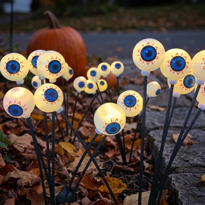 Warm white glowing eye orbs in autumn leaves at twilight
