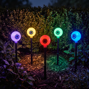Multicolour glowing eye orbs in a flower bed at night