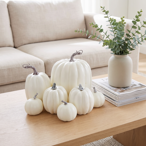 White decorative pumpkins on a pale oak coffee table