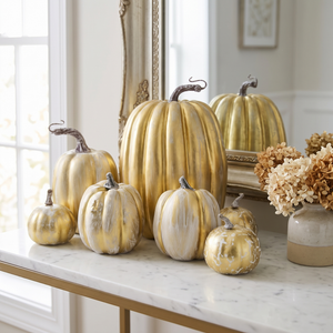 Gold decorative pumpkins on a marble console