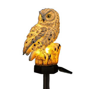 Solar owl garden stake light on a white background