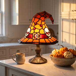 Skull motif witch hat lamp lit on a kitchen counter