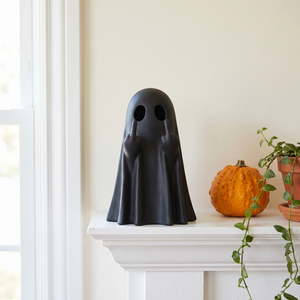 Black ghost statue on a white mantelpiece