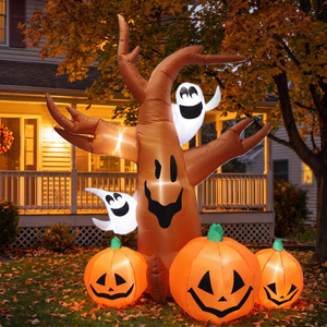 Inflatable pumpkin tree lit on a front lawn at dusk
