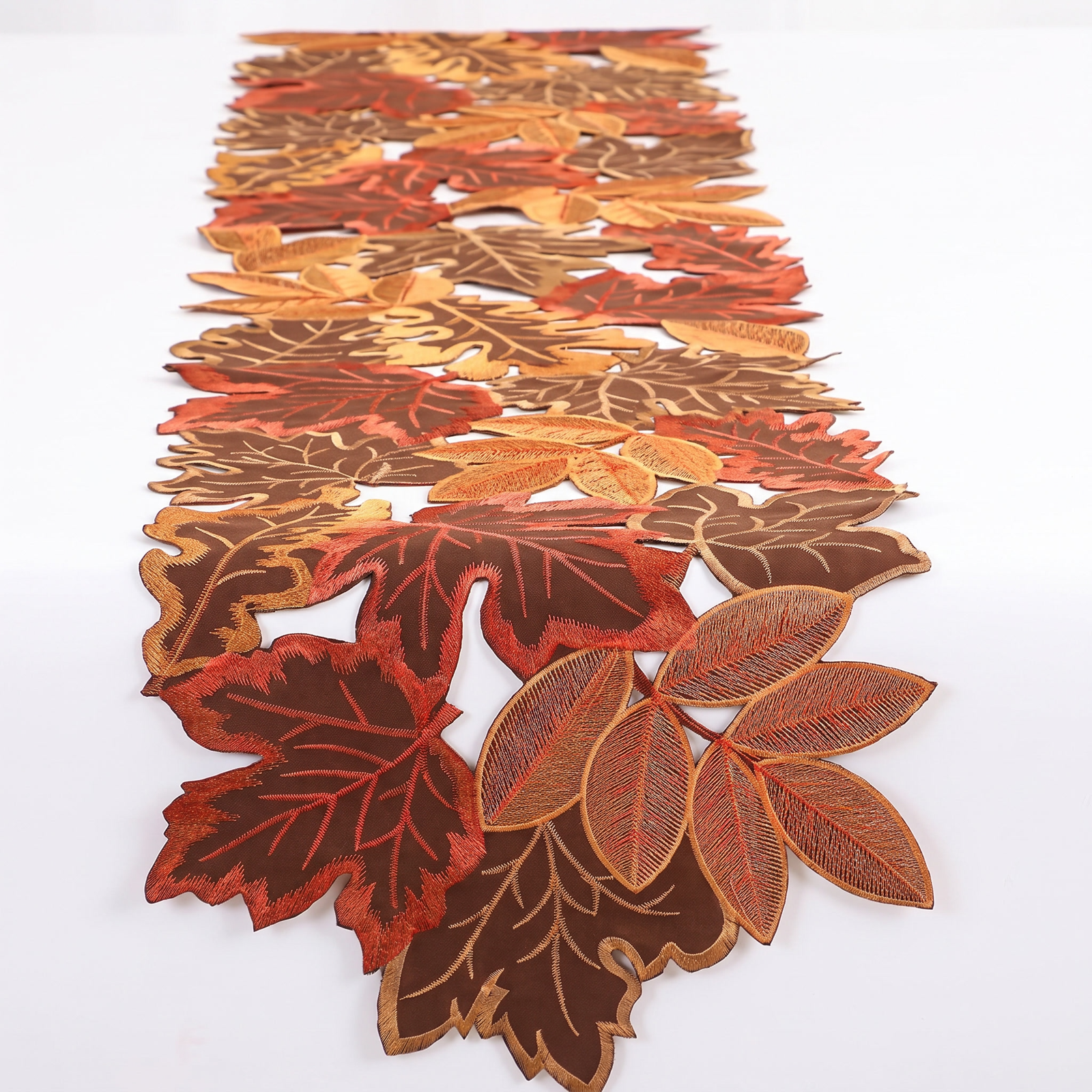 Embroidered autumn leaf table runner on a white background