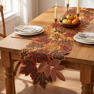 Autumn leaf table runner on a dining table set for dinner