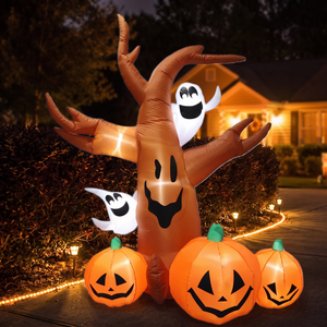 Inflatable pumpkin tree glowing beside a driveway at night