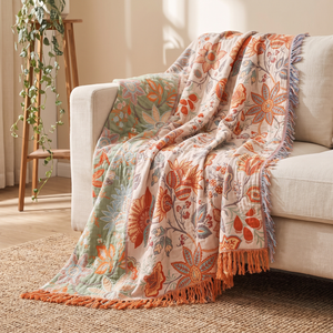 Rustic floral throw blanket draped over a cream linen sofa