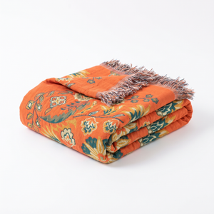 Marigold reversible cotton gauze throw blanket folded on a white background