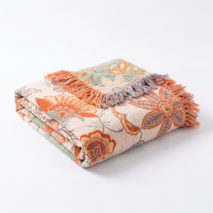 Rustic floral boho cotton throw blanket folded on a white background