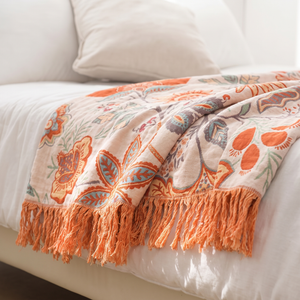Close up of the cotton weave and fringe on the rustic floral blanket