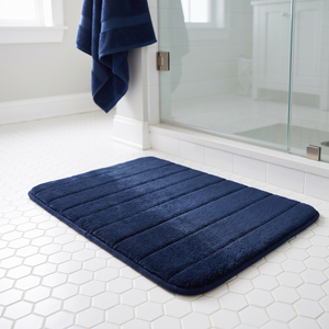 Dark blue bath mat on white hexagon tile