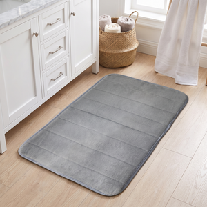 Light grey bath mat on a pale oak bathroom floor