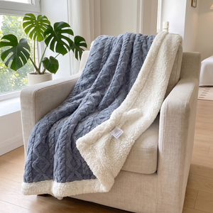 Blue berry sherpa fleece blanket draped over an armchair