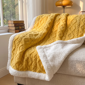 Golden sunrise sherpa fleece blanket on a reading chair