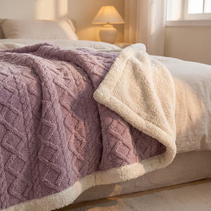 Passion purple sherpa fleece blanket draped across a bed