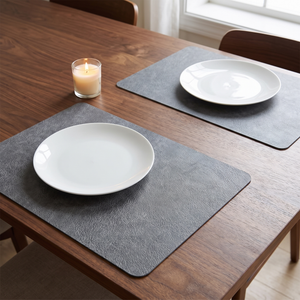 Gray faux leather placemats on a walnut dining table