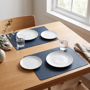 Blue faux leather placemats on a light wood table