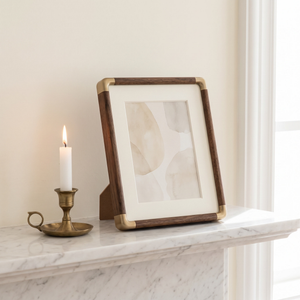 Black walnut photo frame on a marble shelf