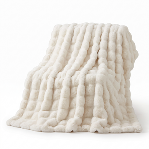 Rabbit faux fur throw blanket draped showing plush ribbed bubble texture