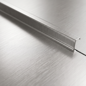 Macro close-up of the brushed stainless steel surface and the raised spill guard lip