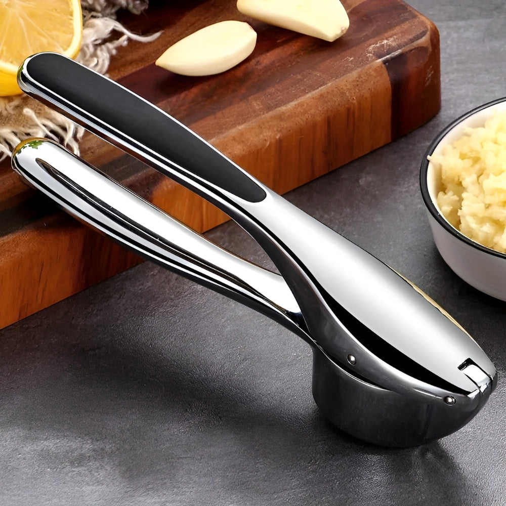Stainless garlic squeezer shown in a kitchen
