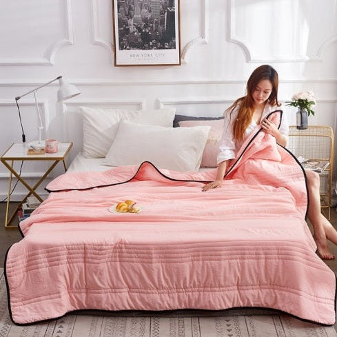 Cooling blanket on a bed