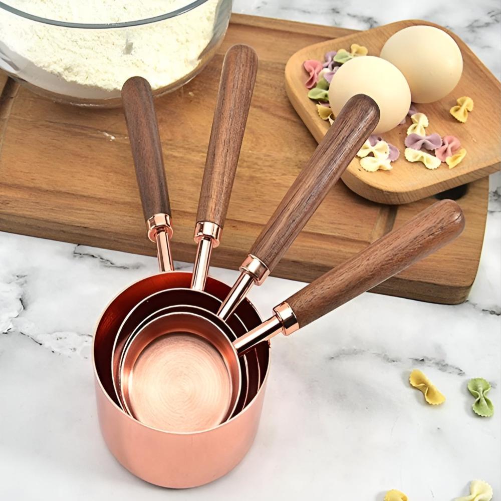 Copper measuring cups and spoons shown in a kitchen