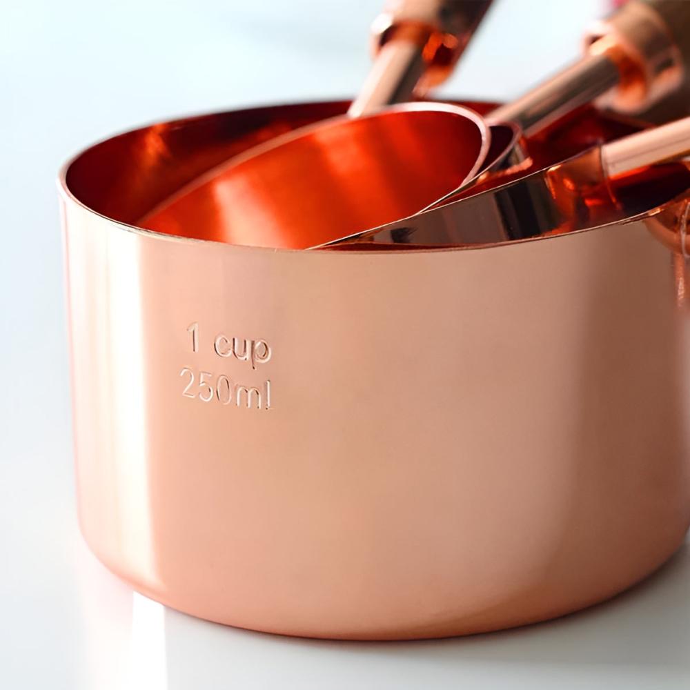 Copper measuring cups and spoons close up view