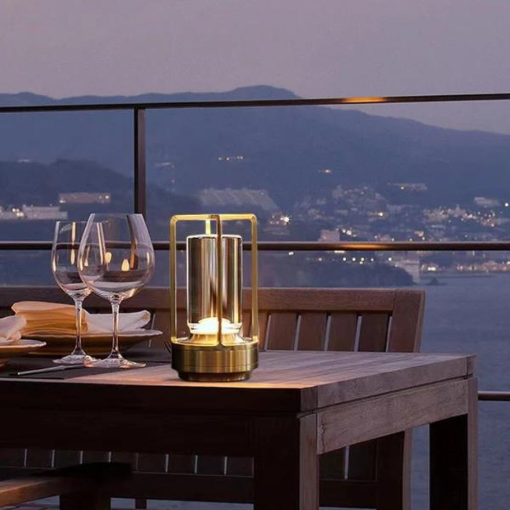 Kaelis lantern lit on an outdoor dining table at dusk