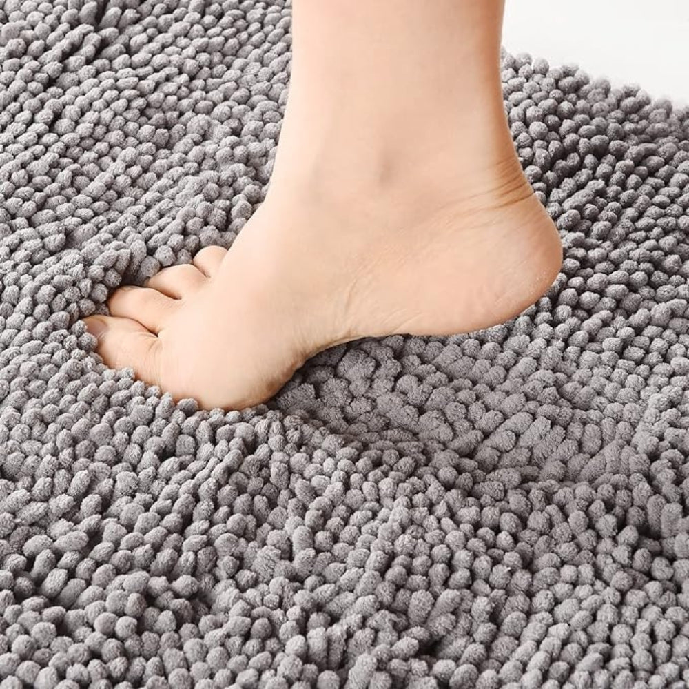 Mavi chenille bath mat on a bathroom floor, view 1