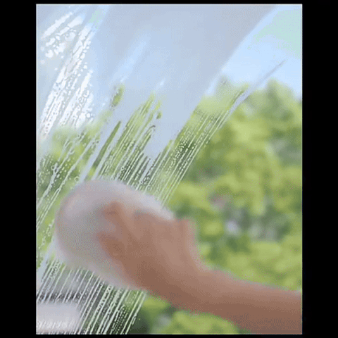 Shower squeegee clearing a glass door