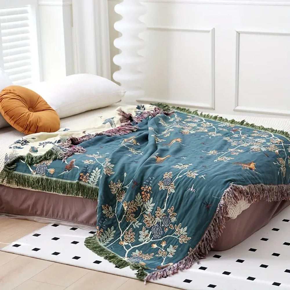 Ornate multi layer cotton gauze blanket on a bed