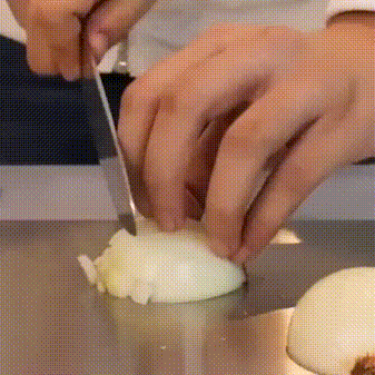 Stainless steel chopping board shown in use