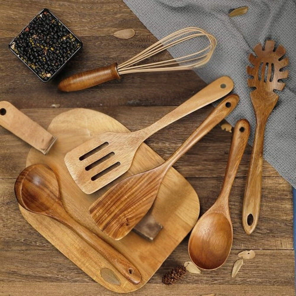 Wooden cooking utensil set shown in use