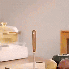 Stainless steel potato masher shown in a kitchen