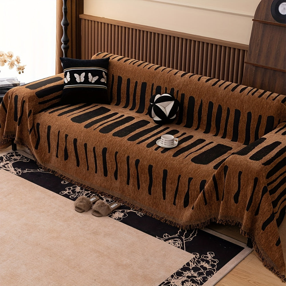 Geometric tribal chenille throw on a sofa
